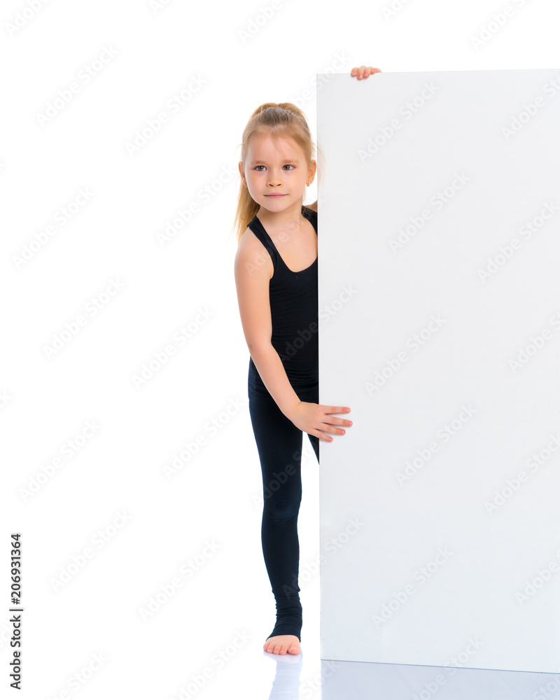 A little girl is looking from behind an empty banner. A little girl is looking from behind an empty banner.