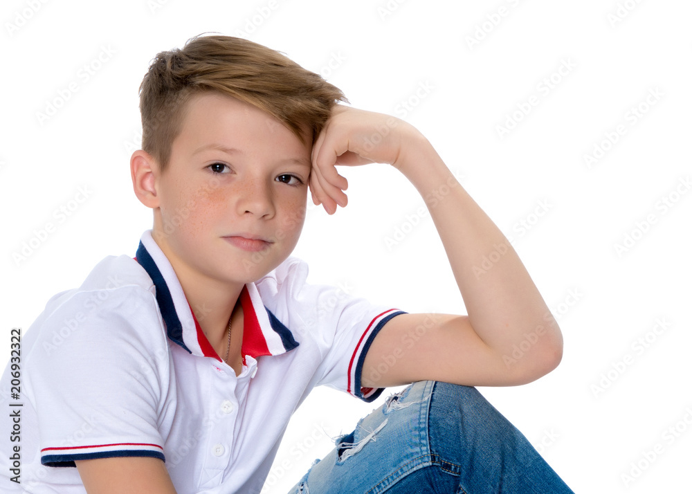 Fashionable boy teen sitting on the floor. Fashionable boy teen sitting on the floor.