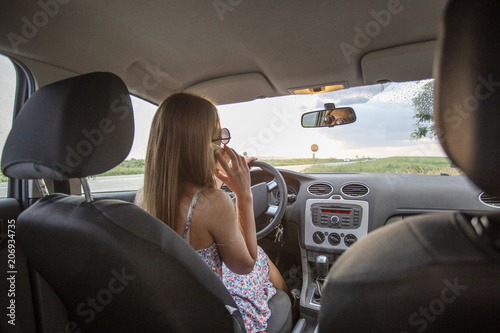Girl drive car and talk on mobile phone