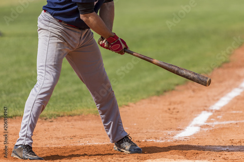 Baseball player holding baseball bat in hand