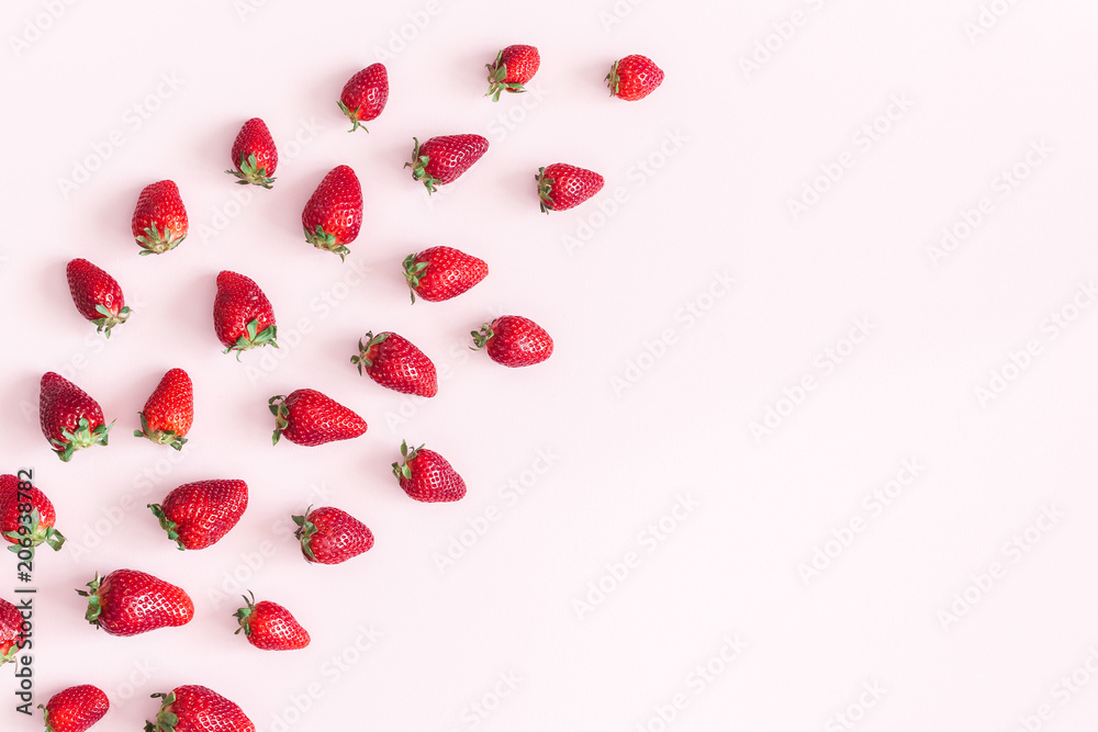 Strawberry on pastel pink background. Flat lay, top view, copy space