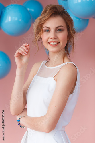 Portrait of attractive tender gentle beautiful fashionable girl with short haircut wearing white evening dress with naked shoulders, isolated on pink background, copy space © oksana_bondar