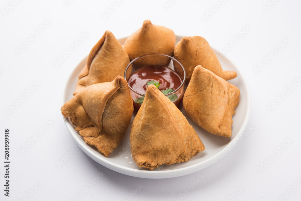 Samosa snack served with tomato ketchup and mint chutney Samosa snack served with tomato ketchup and mint chutney