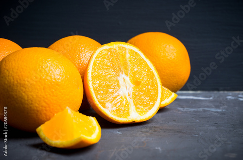 Fresh ripe oranges in the wooden crate. Selective focus.