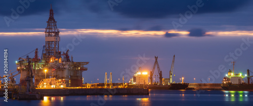 night seaport, container terminal and oil rig
