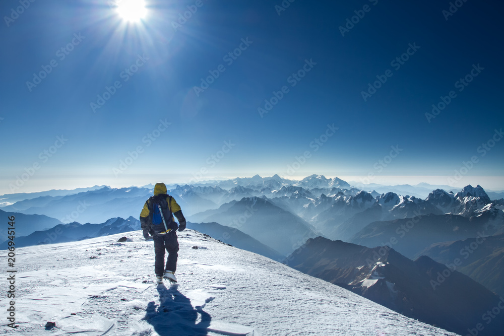 A man stands on top of Mount Elbrus