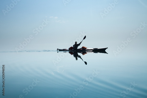 Fototapeta Naklejka Na Ścianę i Meble -  A man in a sea kayak on Lake Baikal