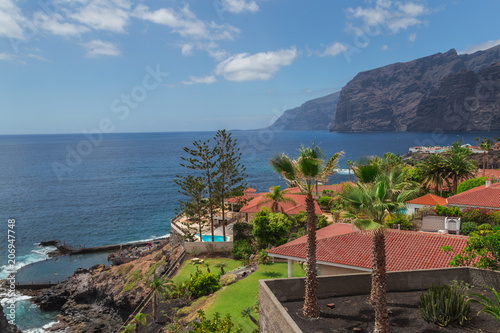 Canary Islands. Los Gigantes coast - Tenerife, Spain. A beautiful view of the houses with red tiles and the huge cliffs of Los Gigantes