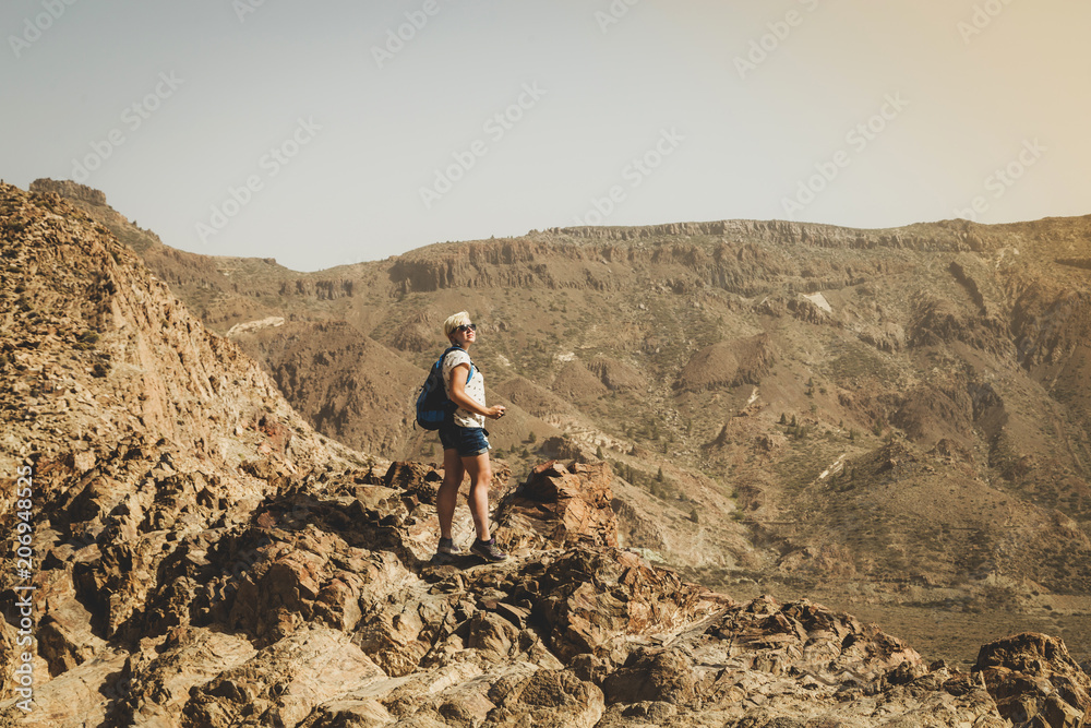 Journey in the desert. Walking hiking stone desert trail dirt road towards mountains. Walking alone in the desert. 