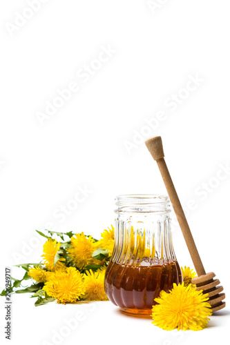 Dandelion flowers and honey jar isolated on white