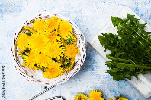 Fototapeta Naklejka Na Ścianę i Meble -  Dandelion flowers in wicker bowl top view