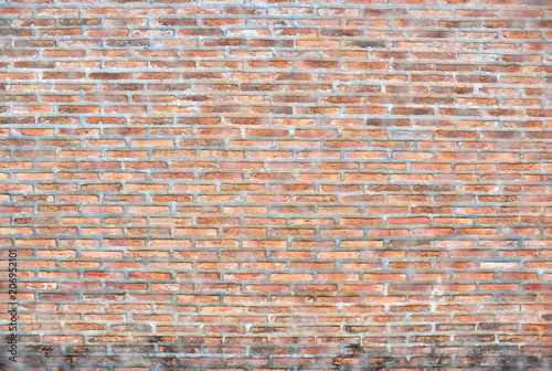 The dirty old red brick wall.