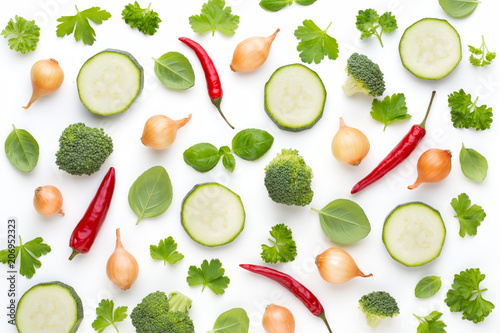 Vegetable and spices isolated on white background, top view. Wallpaper abstract composition of vegetables.