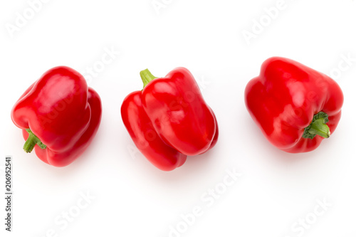 Red bell pepper with half and leaves isolated on white.