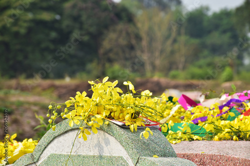 Yellow flowers on tombstone in Shengmen Day that is day people pay homage to the ancestors at the m photo