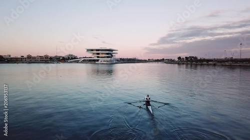 Spain, Valencia aerial shooting, bird-eye view of port, man is rowing in a special sports boat skiff. nice view of a bay and sailboats, cool yachts, nice view of the sea