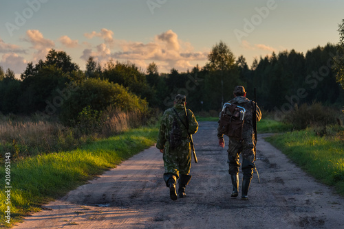 Valokuvatapetti Two hunters go on an evening hunt