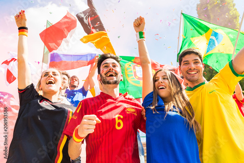 Happy fans supporters from different countries together at stadium
