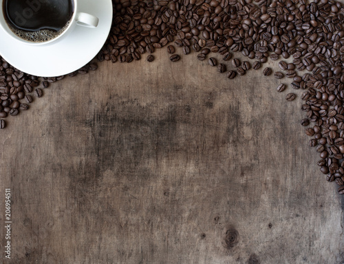 Wooden background with coffee cup and coffee beans