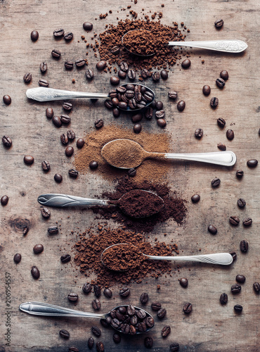 Different kinds of coffees on the spoons (coffee beans, ground coffee, instant coffee)