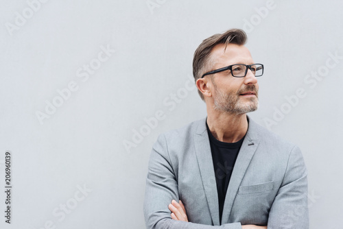 Mature man with glasses wearing grey jacket