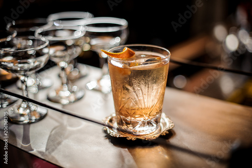 Delicious cocktail standing among empty glasses in bar