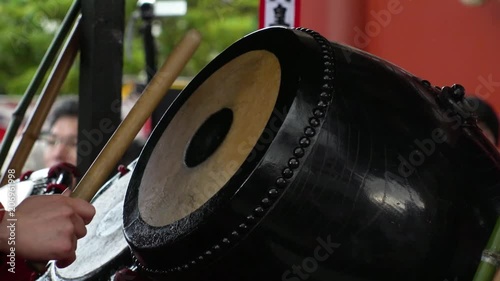 ASAKUSA, TOKYO,  JAPAN - MAY 20, 2018 : Close-up shot of beating Japanese drum at SANJA MATSURI (SANJA FESTIVAL).  In slow motion. photo