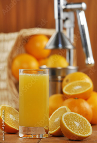 Orange juice on table on wooden background (selective focus)
