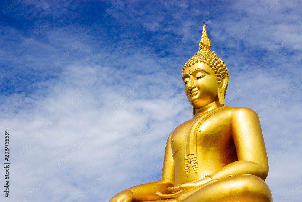 Great Golden Buddha statue in the sky in the daytime.