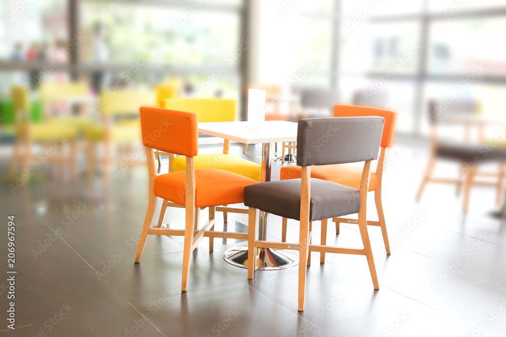 Dining area with colorful tables and chairs Dining area with colorful tables and chairs