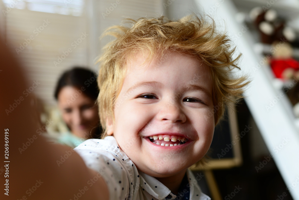 Boy spends fun time in playroom. Child with cheerful face Boy spends fun time in playroom. Child with cheerful face