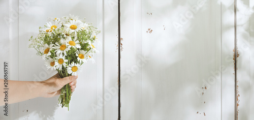 Fototapeta Naklejka Na Ścianę i Meble -  Hand holding bouquet of flower