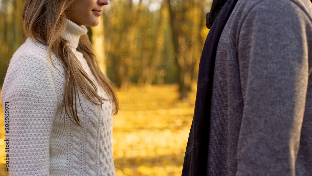 Man and woman dating in autumn forest, falling in love, romantic atmosphere Man and woman dating in autumn forest, falling in love, romantic atmosphere