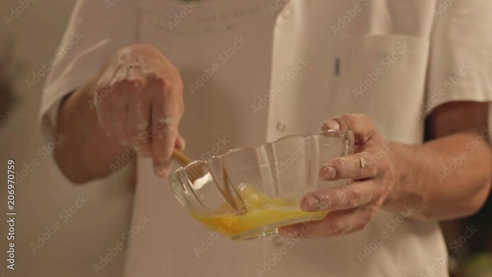 Close-up of man mixing eggs in bowl. Shot in Cinestyle color profile (good for color grading). Close-up of man mixing eggs in bowl. Shot in Cinestyle color profile (good for color grading).