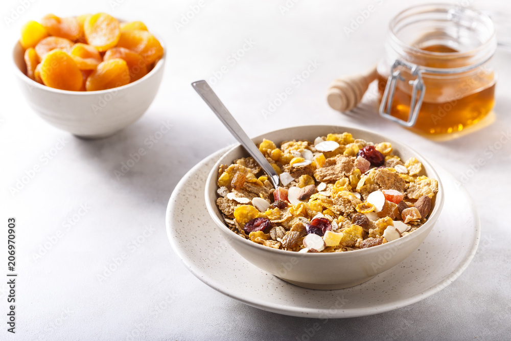 Muesli served with honey and dried apricots. Muesli served with honey and dried apricots.