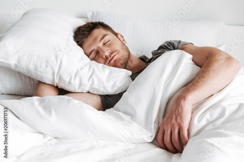 фотографія Handsome young man sleeping in bed