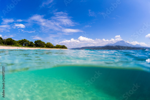 Tropical beach on Bali. Split shot with underwater view of the tropical beach located on the island of Bali, Indonesia