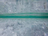 Underwater view of a salty lake which is located at Uyuni salt flat in Bolivia. Thin layer of water covers some parts of Uyuni salt flat. Image contains some artifacts.