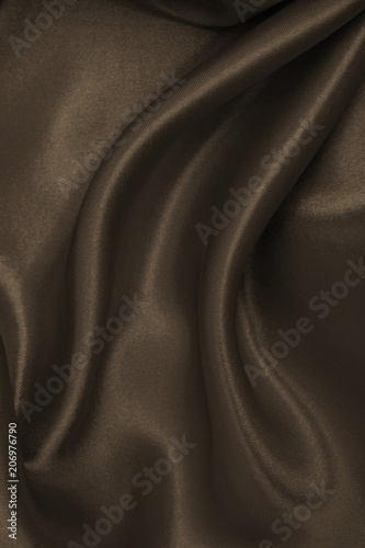 Smooth elegant brown silk or satin texture as abstract background. Luxurious background design wallpaper. In Sepia toned. Retro style