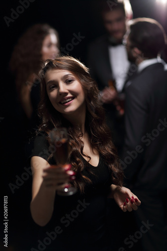 beautiful young woman raising his glass in a casino