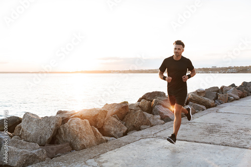 Fototapeta Naklejka Na Ścianę i Meble -  Portrait of a healthy sportsman jogging