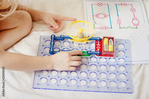 The child collects an electronic constructor