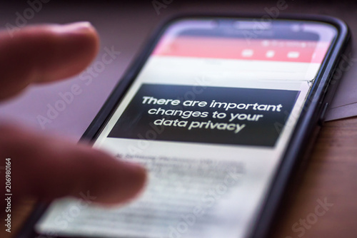 General Data Protection Regulation - GDPR - closeup human finger pointing to smartphone message There Are Important Changes To Your Data Privacy photo