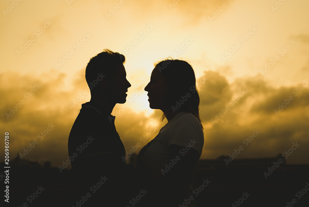 Backlight of a couple kissing