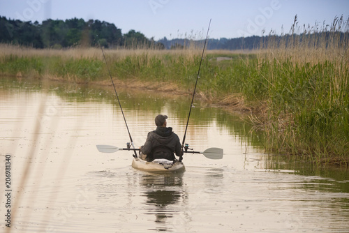 Fisherman in canoe.