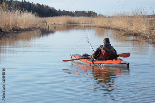 .Recreational fishermen in small kayak.
