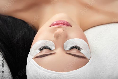 Bild auf Leinwand Young girl lying with beatiful long enlarged lashes