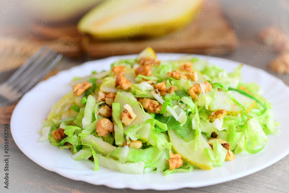 Homemade cabbage slaw with pear and walnuts. Easy pear and cabbage slaw on a plate. Food highest in vitamins. Closeup