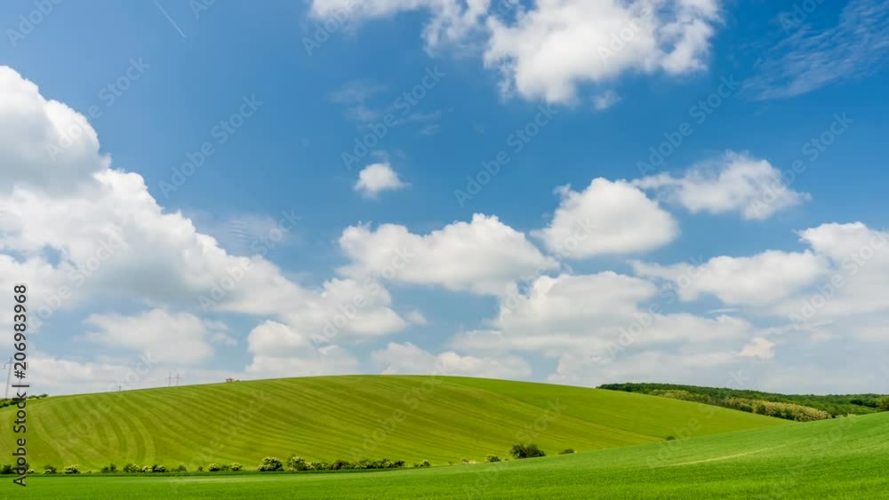 Time Lapse footage of beautiful landscape. White clouds passing above rural fields in South Moravia, Czech Republic.