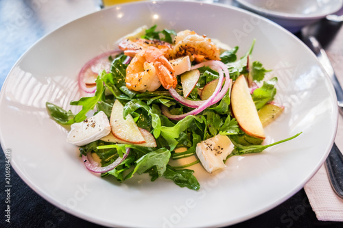 Starter with shrimps, brie, fresh salad leaves and vegetables